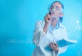 Schoolgirl writing chemistry formula on glass board against color background