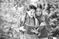 Schoolgirls with backpacks and textbooks, forest school concept