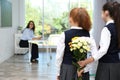 Schoolgirls with bouquet congratulating their pedagogue in classroom. Teacher`s day
