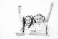 Schoolgirls happy keep hands up while sit at desk white background. Win school quiz. They know right answer. Schoolgirls