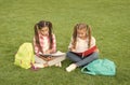 Schoolgirls little children school yard with books, interesting reading concept Royalty Free Stock Photo