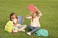 Schoolgirls little children school yard with books, learning language concept Royalty Free Stock Photo