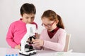 Schoolgirls with modern microscope Royalty Free Stock Photo