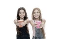 Schoolgirls with mugs having tea break. Relax and recharge. Water balance concept. Enjoying tea together. Sisters or Royalty Free Stock Photo