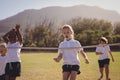 Schoolgirls running toward finishing line during egg and spoon race