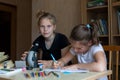 Schoolgirls teen studying lessions with microscope