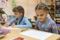 Schoolgirls at their desks in drawing class