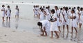 Schoolgirls in uniform playing at the beach