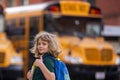 Schoolkid getting on the school bus. American School. Back to school. Kid of primary school. Happy children ready to Royalty Free Stock Photo