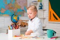 Schoolkid or preschooler learn. Child near chalkboard in school classroom. Chalkboard copy space. Home schooling.