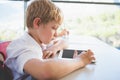 Schoolkid using digital tablet in classroom