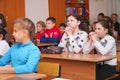Schoolkids in the classroom listen to the teacher