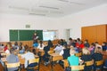 Schoolkids in the classroom sitting at their desks and listen to the teacher