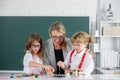 Schoolkids with teacher. Happy children from elementary school study at draw lesson. Teacher and little students Royalty Free Stock Photo