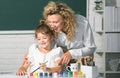 Schoolkids with teacher. Teacher and little students portrait, teachers day. Happy children from elementary school study Royalty Free Stock Photo