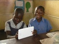 African cchoolkids using tablet in classroom at school. Royalty Free Stock Photo