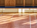 Schooll gym hall with heating system over wooden bars cover