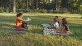 Schoolmistress teaching geography lesson to mixed race pupils outdoors