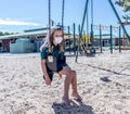 Schools closures Coronavirus lockdown. Bored school kid alone in playground feeling sad and lonely Royalty Free Stock Photo