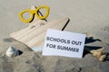 SCHOOLS OUT FOR SUMMER text on paper greeting card on background of funny starfish in glasses summer vacation decor Royalty Free Stock Photo