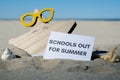 SCHOOLS OUT FOR SUMMER text on paper greeting card on background of funny starfish in glasses summer vacation decor Royalty Free Stock Photo