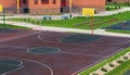 Schoolyard with a playground for basketball.