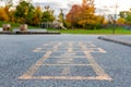 School and schoolyard with hopscotch and playground for elementary students in evening in fall season Royalty Free Stock Photo