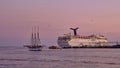 Schooner Past Cruise Ship at Sunset