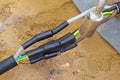 Heat-shrink tubing over underground cables is shrunk with a gas flame