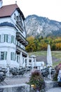 SCHWANGAU, GERMANY - OKTOBER 09, 2018: Cafe near a building in a park in the morning in the Alps