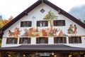 SCHWANGAU, GERMANY - OKTOBER 09, 2018: Painted scene of feast on the wall of a house in a village in the Alps