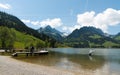 Schwarzsee, FR / Switzerland - 1 June 2019: tourists enjoy the summer lakeside view at the Schwarzsee Lake in the Swiss Alps in