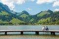 Schwarzsee, FR / Switzerland - 1 June 2019: two men best friends enjoy the summer lakeside view at the Schwarzsee Lake in the