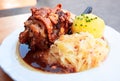 Schweinshaxe, German cuisine with pork knuckle, cabbage and pota Royalty Free Stock Photo