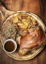 SCHWEINSHAXE traditional german pork knuckle with sauerkraut and potatoes meal Royalty Free Stock Photo