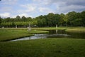 Schwerin, Germany - July 20, 2021 - The Castle Garden with statues and small bridges in the cloudy summer afternoon