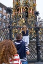 Nuremberg Schoner Brunnen Fountain with tourists lined up to turn the lucky brass rings