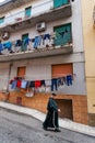 SCIACCA, ITALY - October 18, 2009: the priest crossing the road