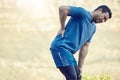 This sciatic nerve is such a problem. a handsome young man standing alone and suffering from backache during his outdoor Royalty Free Stock Photo