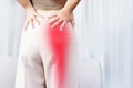 Sciatica Pain concept with woman suffering from buttock pain spreading to down leg Royalty Free Stock Photo