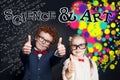 Science and art concept. Happy kids showing thumb up