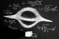 Science and black holes.Basic properties of black holes. A scientist writes physical and mathematical formulas on a