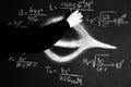 Science and black holes.Basic properties of black holes. A scientist writes physical and mathematical formulas on a
