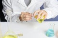 Science, chemistry, biology, medicine and people concept - close up of young female scientist holding test tube sample Royalty Free Stock Photo