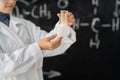 science, chemistry, research and people concept. close up of scientist hands holding test flask with chemical over Royalty Free Stock Photo