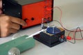 Science classroom, students are conducting a physics experiment on the speed of objects using a ticker timer device.