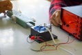 Science classroom, students are conducting a physics experiment on the speed of objects using a ticker timer device.