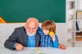 Science education concept. Teacher with male elementary school pupil with problem. Royalty Free Stock Photo