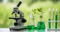 Science equipment with microscope and green liquid in flasks and test tubes on a table outdoors Royalty Free Stock Photo