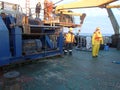 The Sea of Okhotsk / Russia - July 17 2015: Science expedition team near the winch on the stern of RV Akademik Lavrentyev hoisting